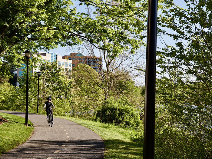 Person rides a bicycle near Merriweather District.