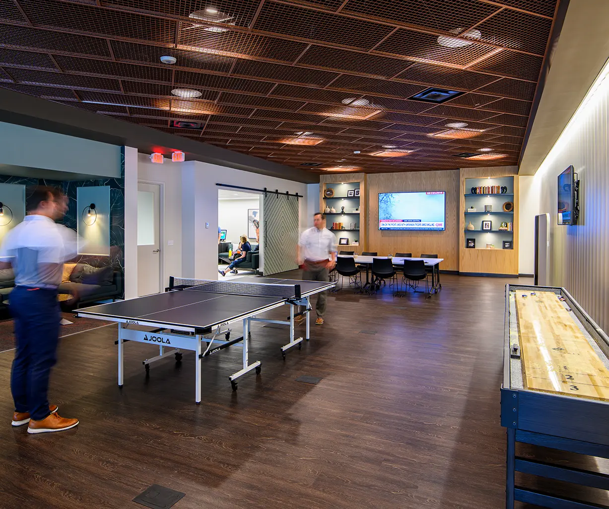 People play paddleball in the Amenity Lounge at 10490 at Merriweather District in Columbia, Maryland.