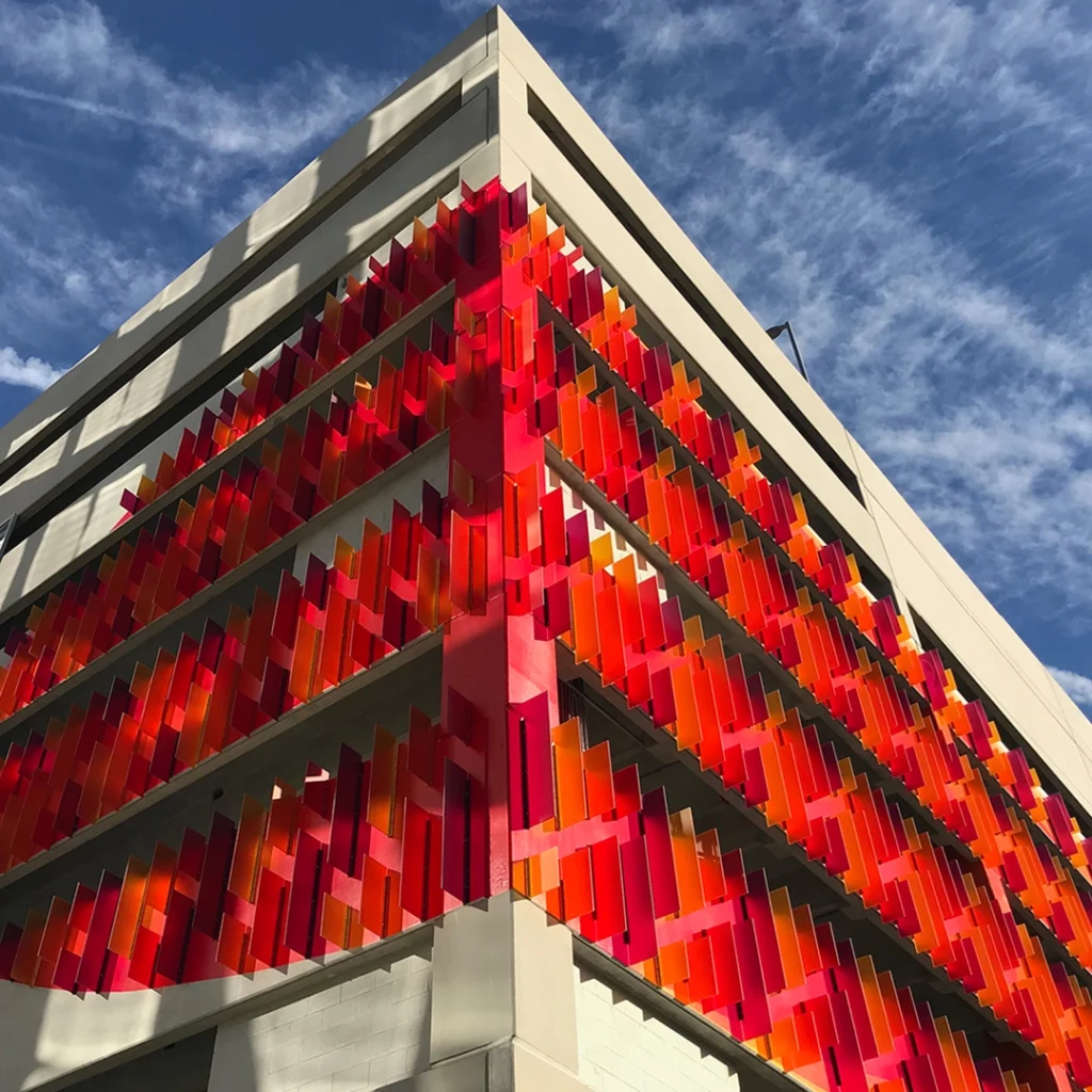 Red, artistic exterior panels at One and Two Merriweather Garages.