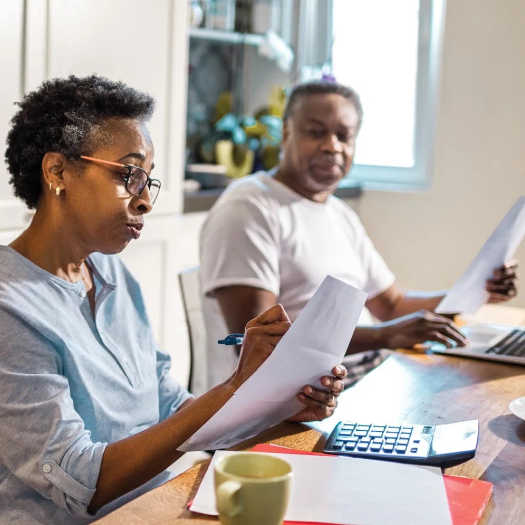 Man and woman fill out paperwork.