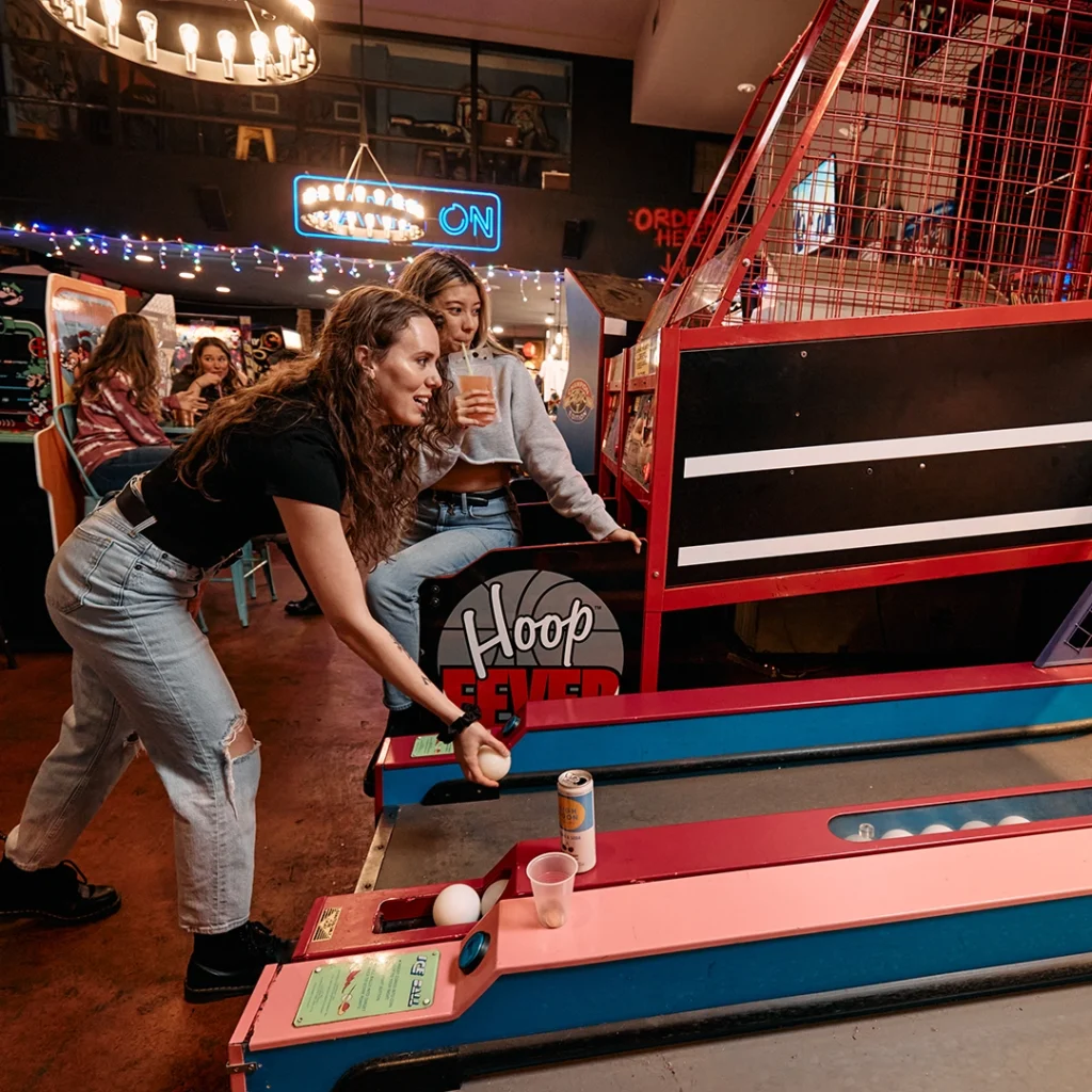 People play games at Game On Bar + Arcade.