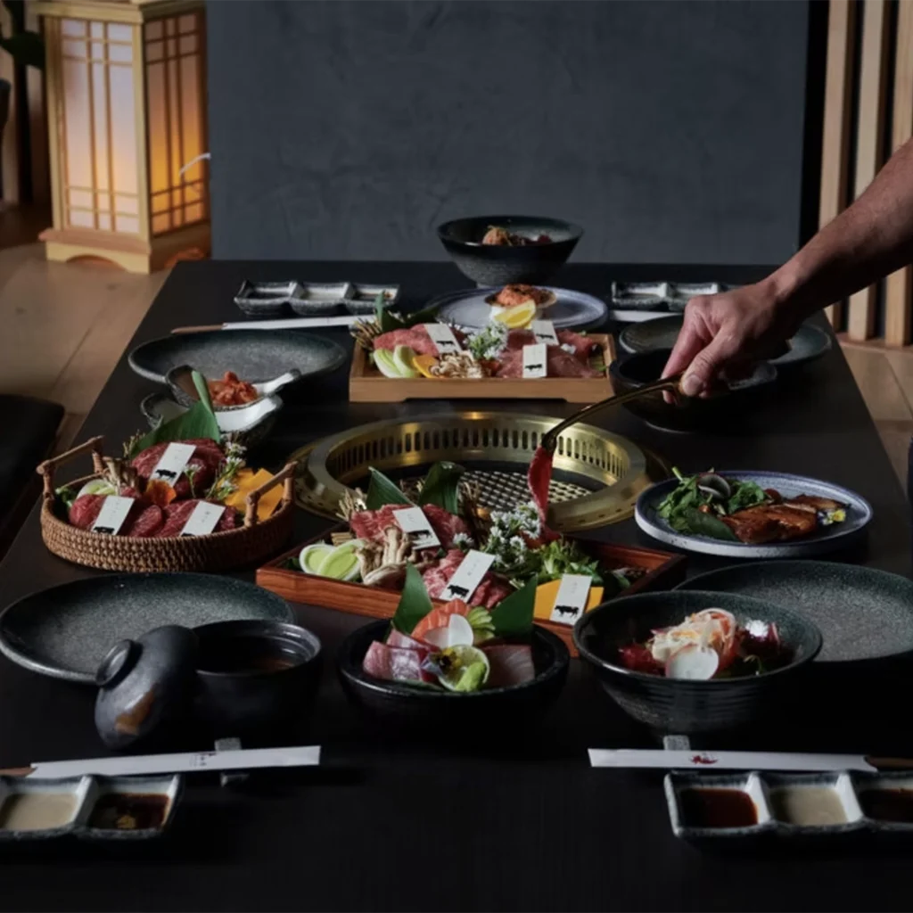 Person prepares food at Gyusan at Merriweather District.