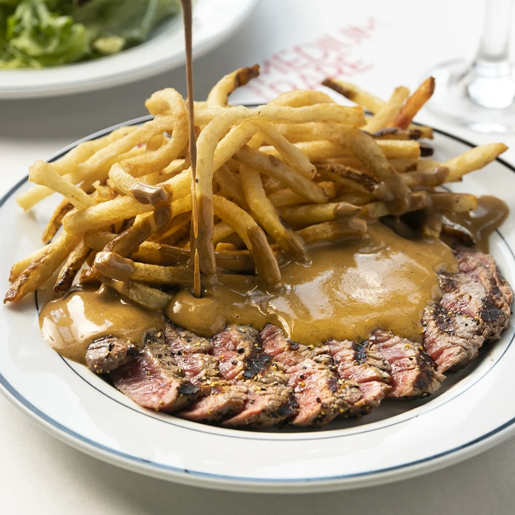 Steak and fries on a plate at Medium Rare.