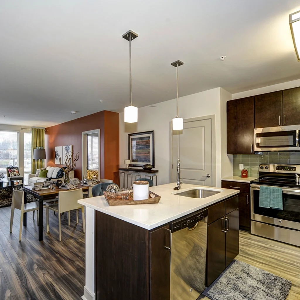 The Metropolitan apartment interior with pendant lights and wood cabinets.
