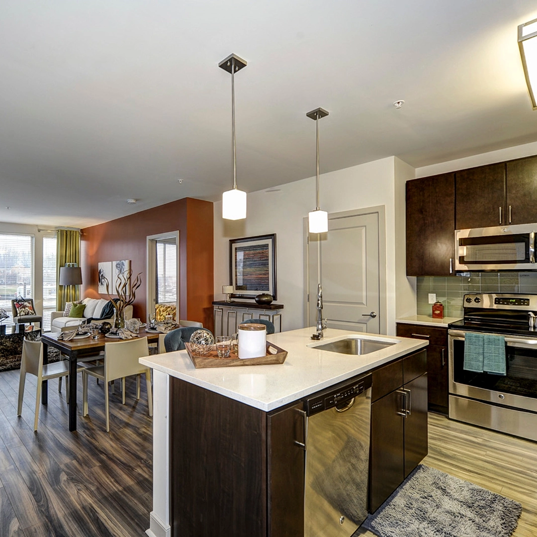 The Metropolitan apartment interior with pendant lights and wood cabinets.