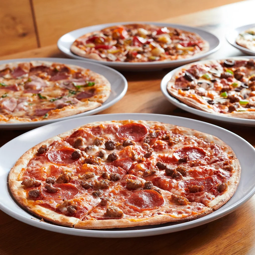 Variety of round pizzas at Mod Pizza.