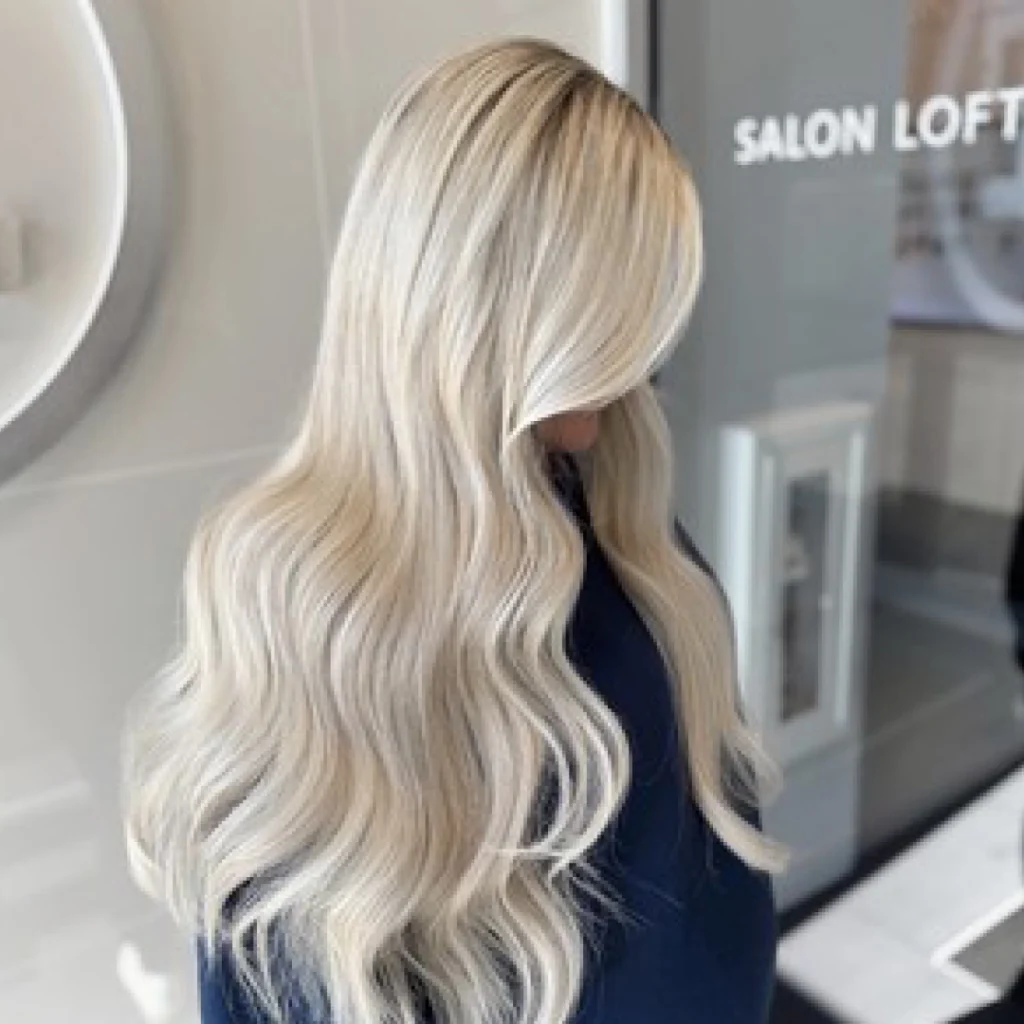 Woman with long blond hair at Salon Lofts.