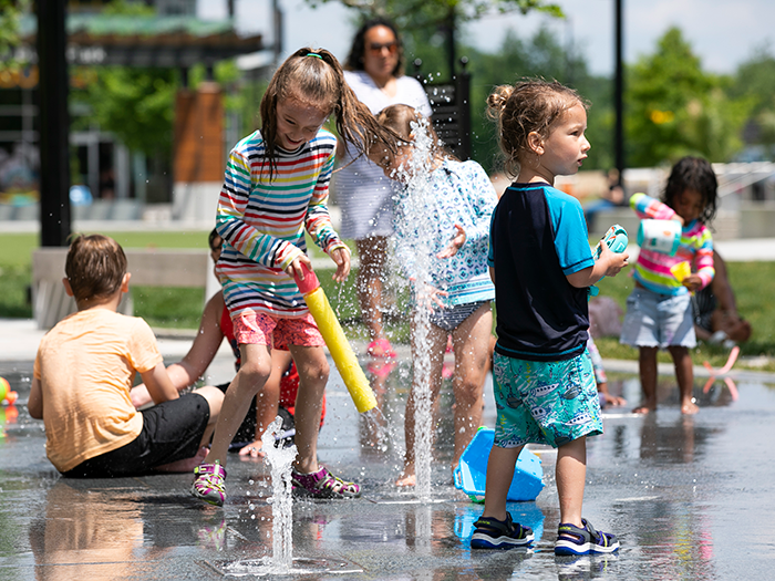 Splash Pad // OPEN Today Kids playing at the splash pad at Merriweather District in Columbia, MD.