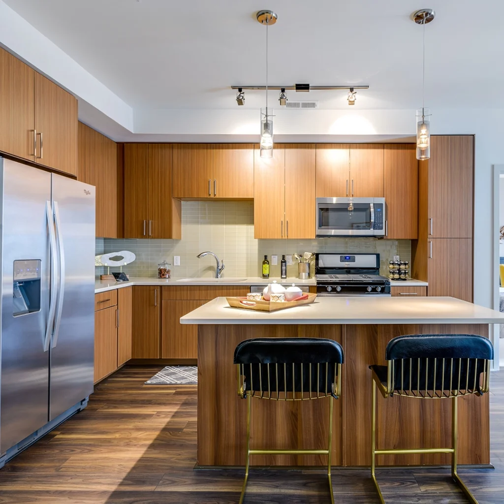 Ten M apartment kitchen with wood cabinets and an island.