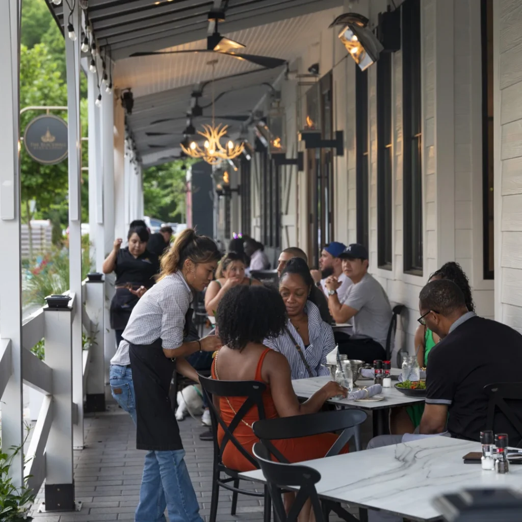 Servers help customers dining on the patio at Blackwall Barn & Lodge in Merriweather District, Columbia, Maryland.