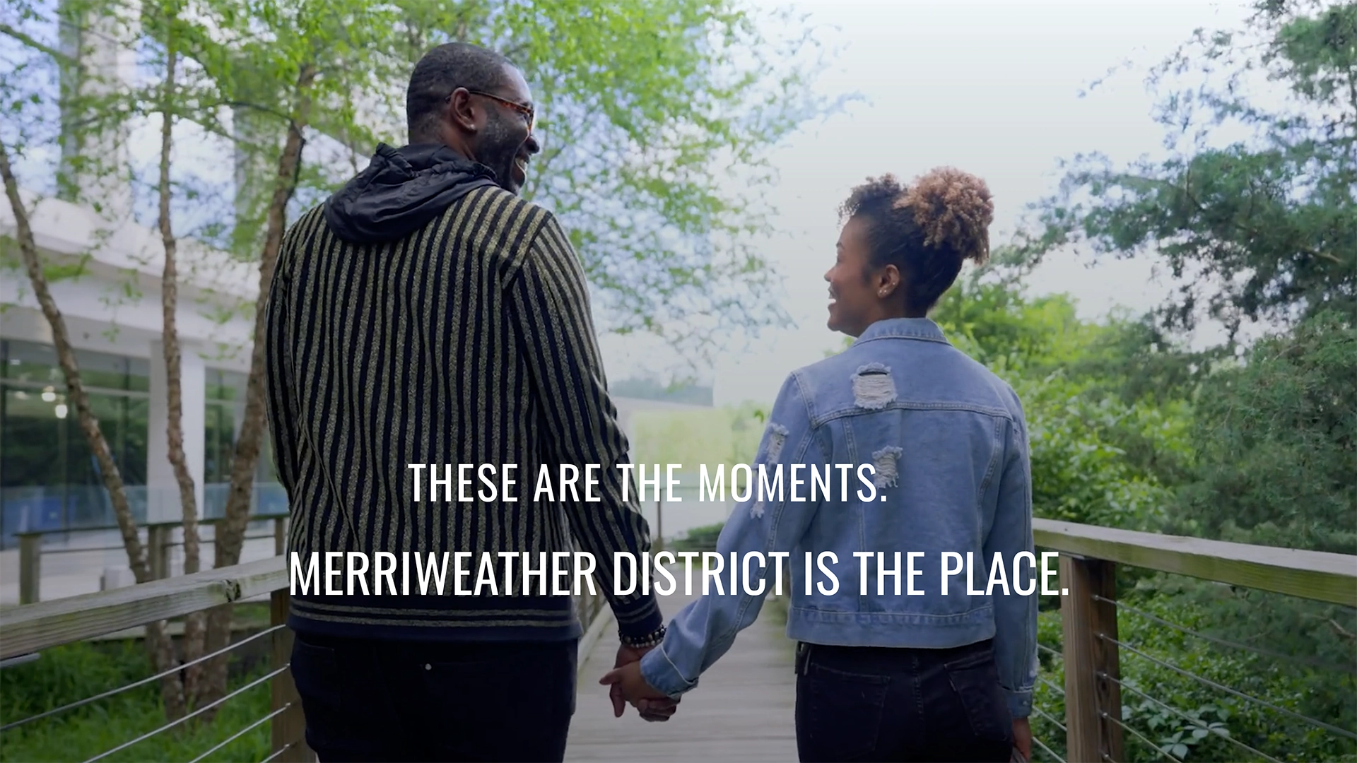 Couple holds hand, text reads "These are the moments. Merriweather District is the place."