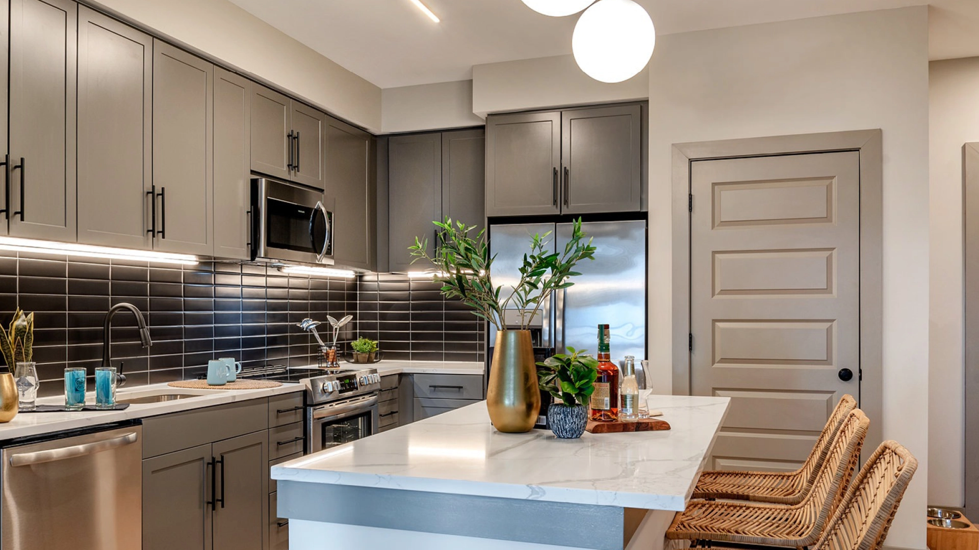 Inside a modern apartment kitchen with island at Merriweather District.
