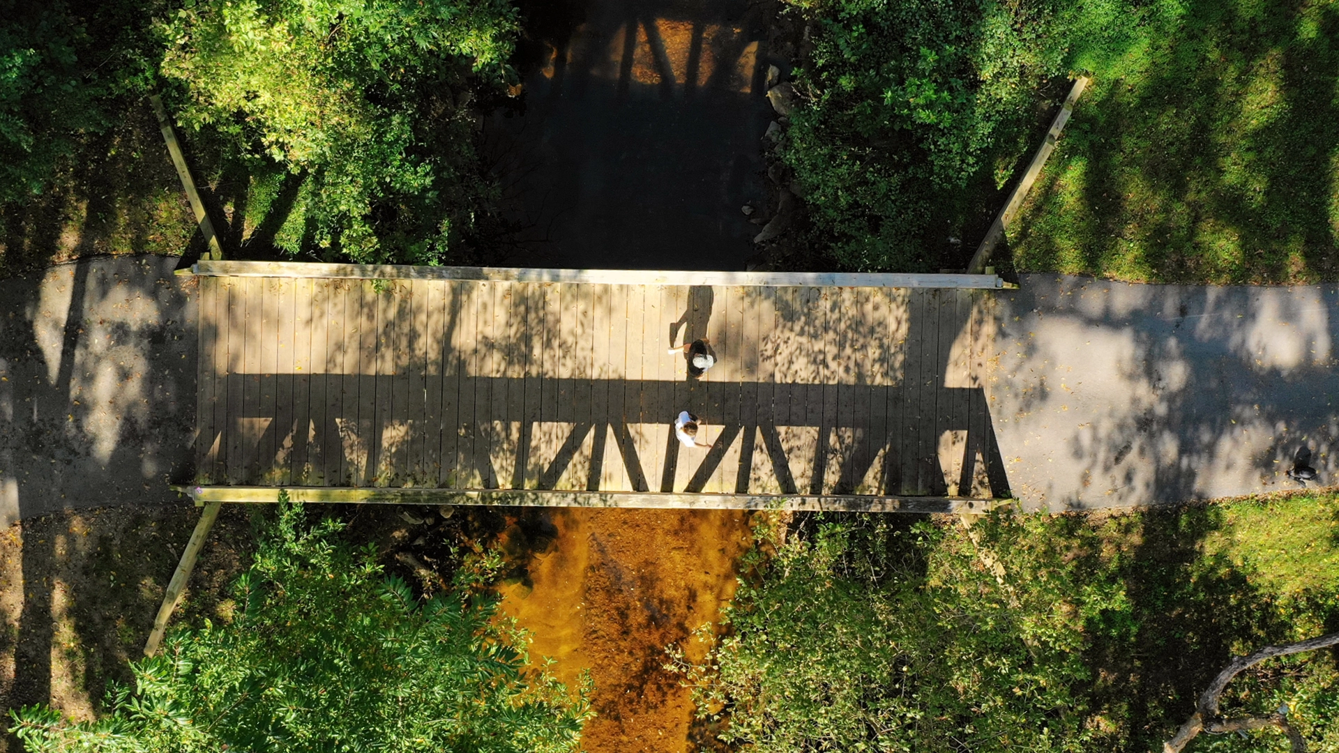 Aerial of people walking on a bridge at Merriweather District in Columbia, Maryland.