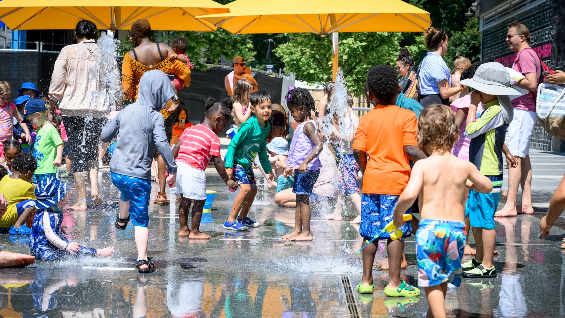 Kids and families play at splash pad at Merriweather District in Columbia, Maryland.