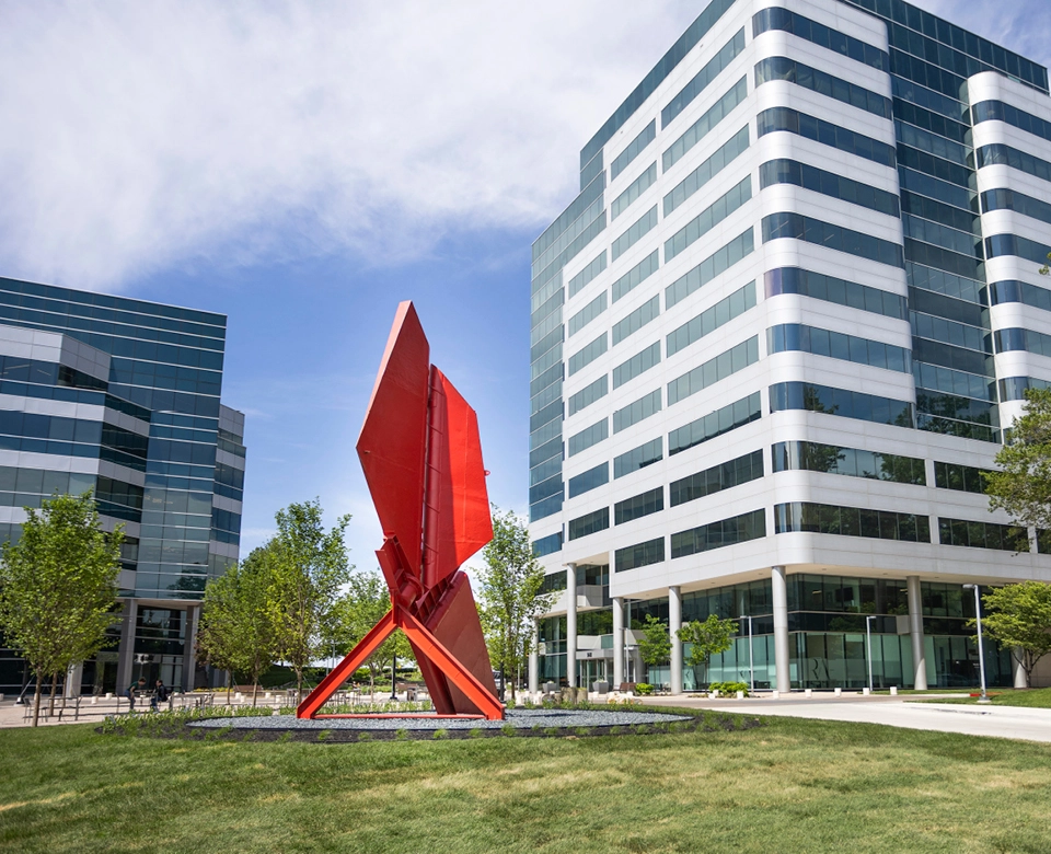 Red sail sculpture outside office buildings at Merriweather District.