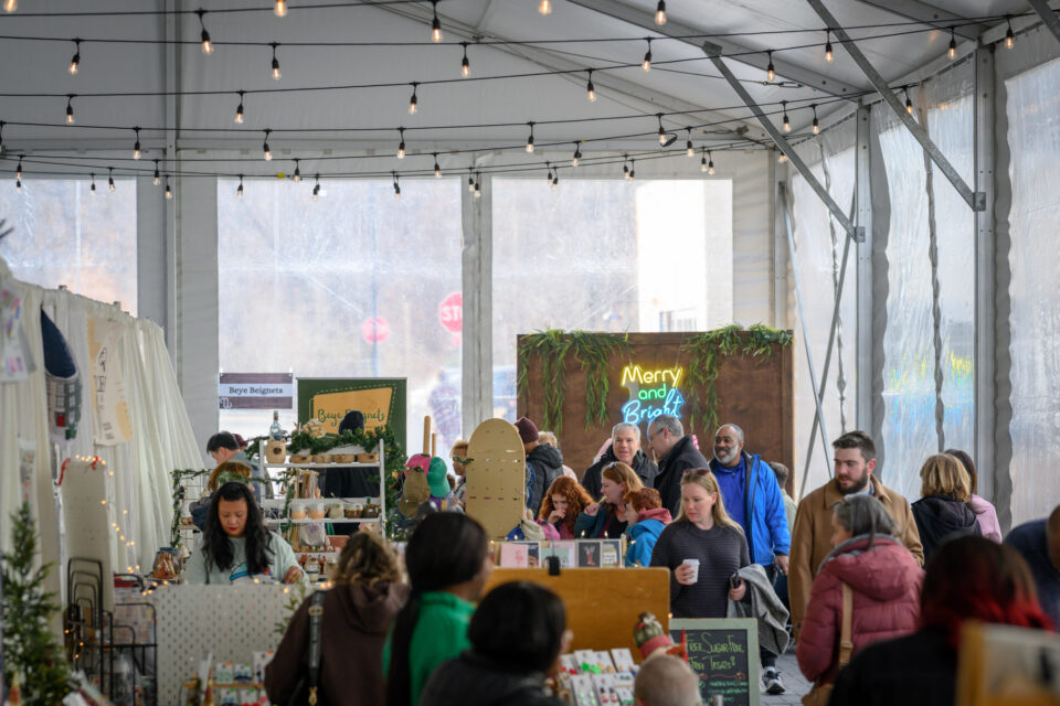 Guests shop at the 2025 Merriweather District Annual Holiday Market surrounded by holiday decor
