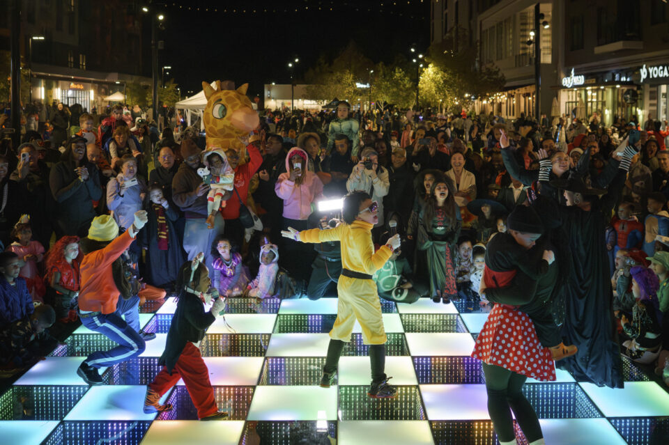 Crowd in costumes celebrating the annual Merriweather District Spook-tacular